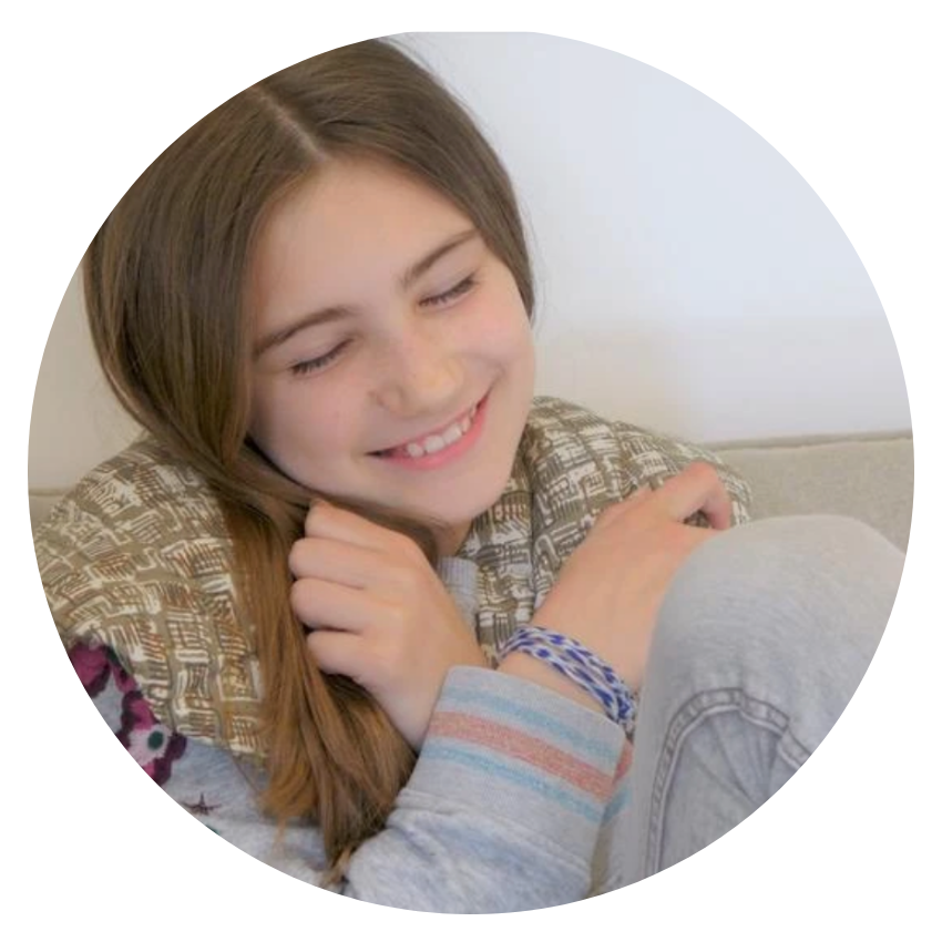 Young girl enjoying her weighted wrap around her shoulders | Like a hug from Nanna | Hug Patrol